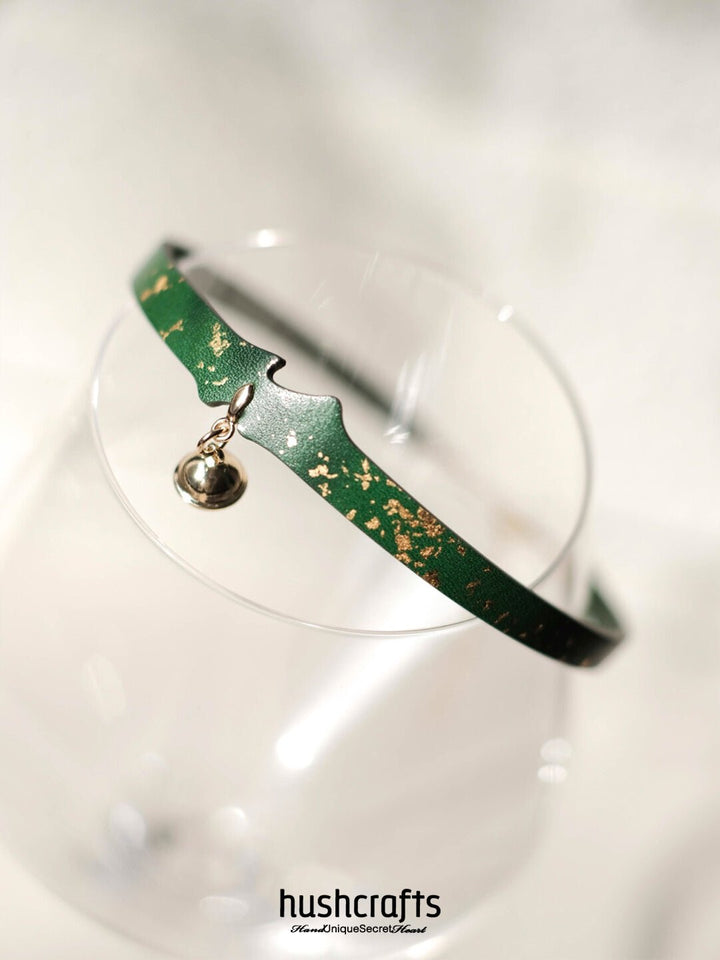 HushCrafts green goatskin day collar with scattered gold details and golden bell pendant – a chic leather choker for everyday wear.