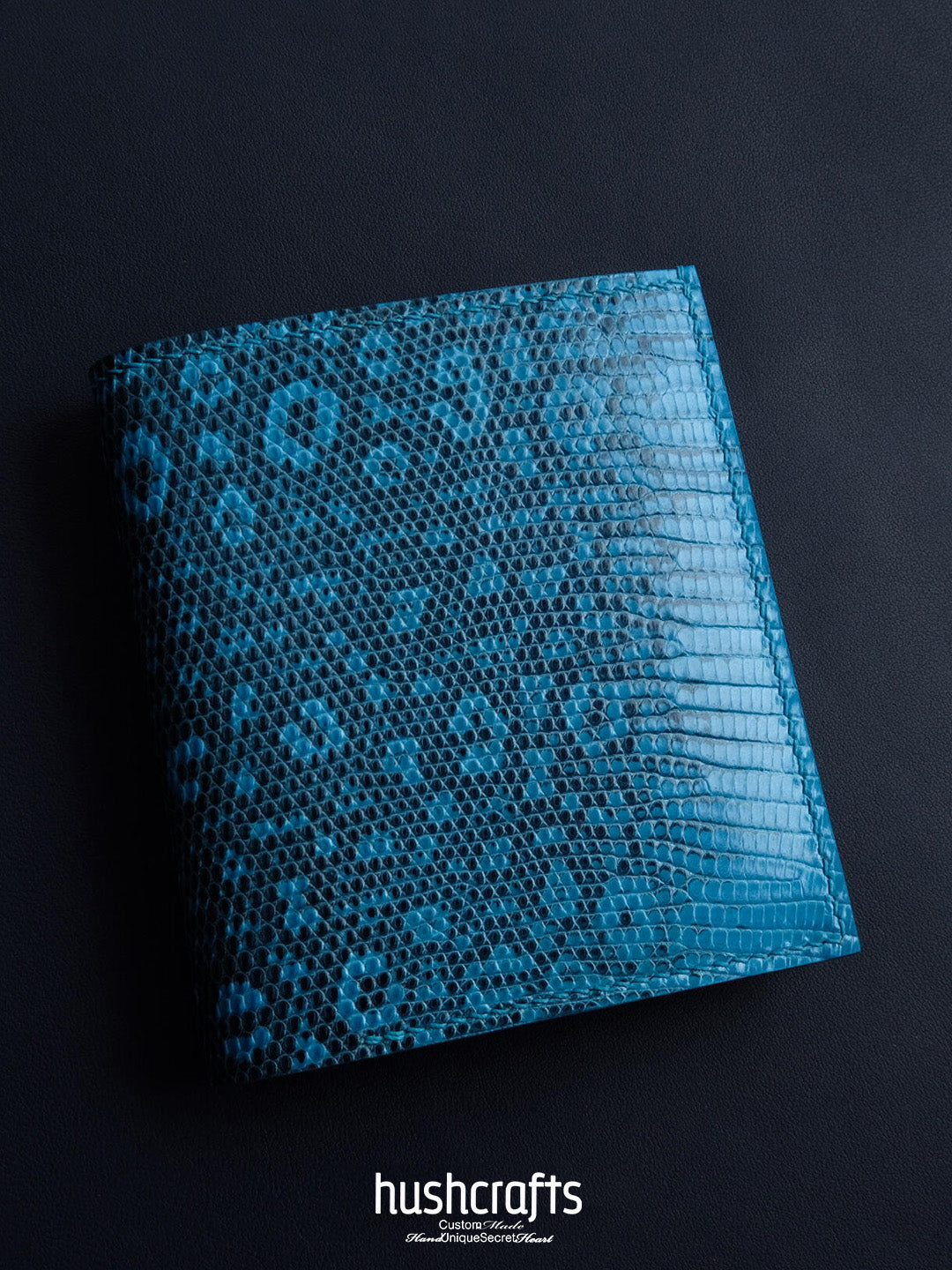 Blue textured notebook with 'hushcrafts' branding on a black background