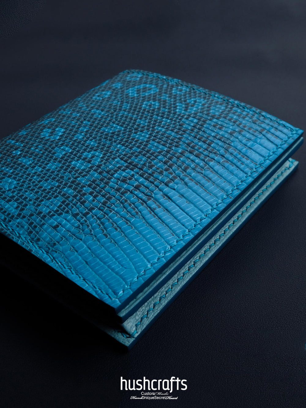 Blue textured card holder with 'hushcrafts' branding on a black background