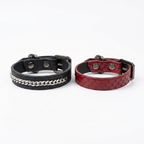 Cuff Set separated – black chain cuff and red python cuff, top-down
