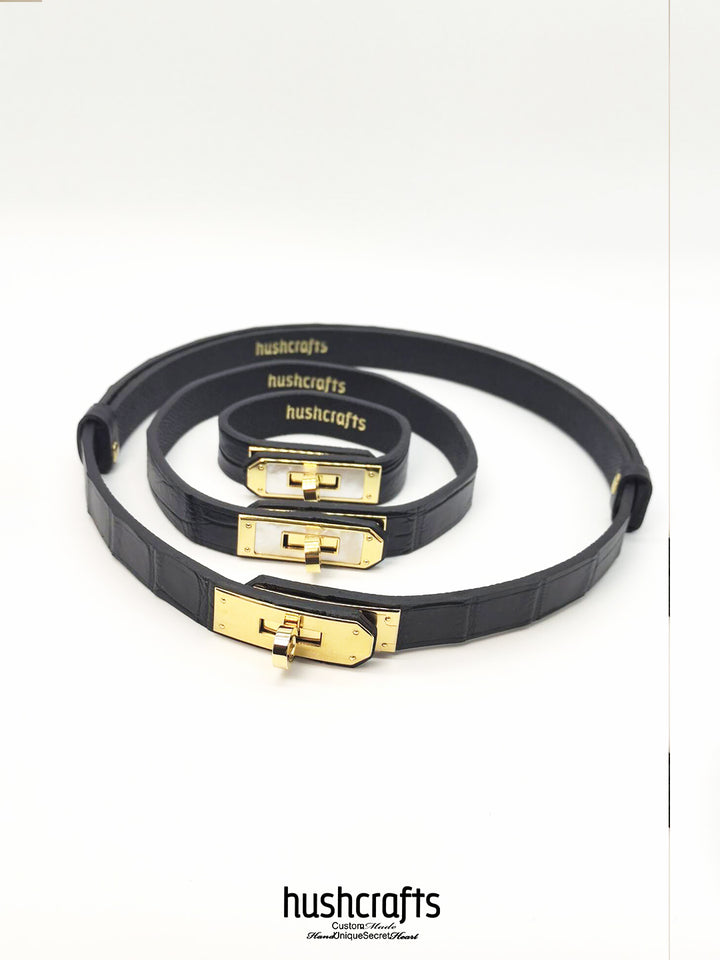 Black leather choker with gold clasps on a white background, featuring the Hushcrafts brand.