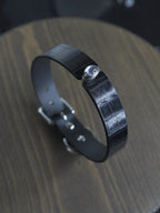 Elegant black leather collar necklace with a padlock detail and chain locking feature. Perfect for BDSM enthusiasts and those who appreciate quality submissive jewelry. Designed for confident wearers, exclusively from HushCrafts.