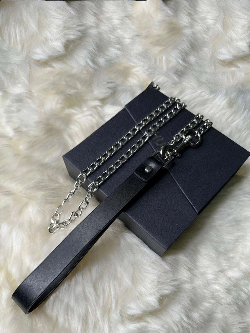 A sleek black leather collar with a strong chain lock design, perfect for those who appreciate bdsm necklace styles. This piece offers both style and functionality, ideal for a bold, submissive look by HushCrafts.