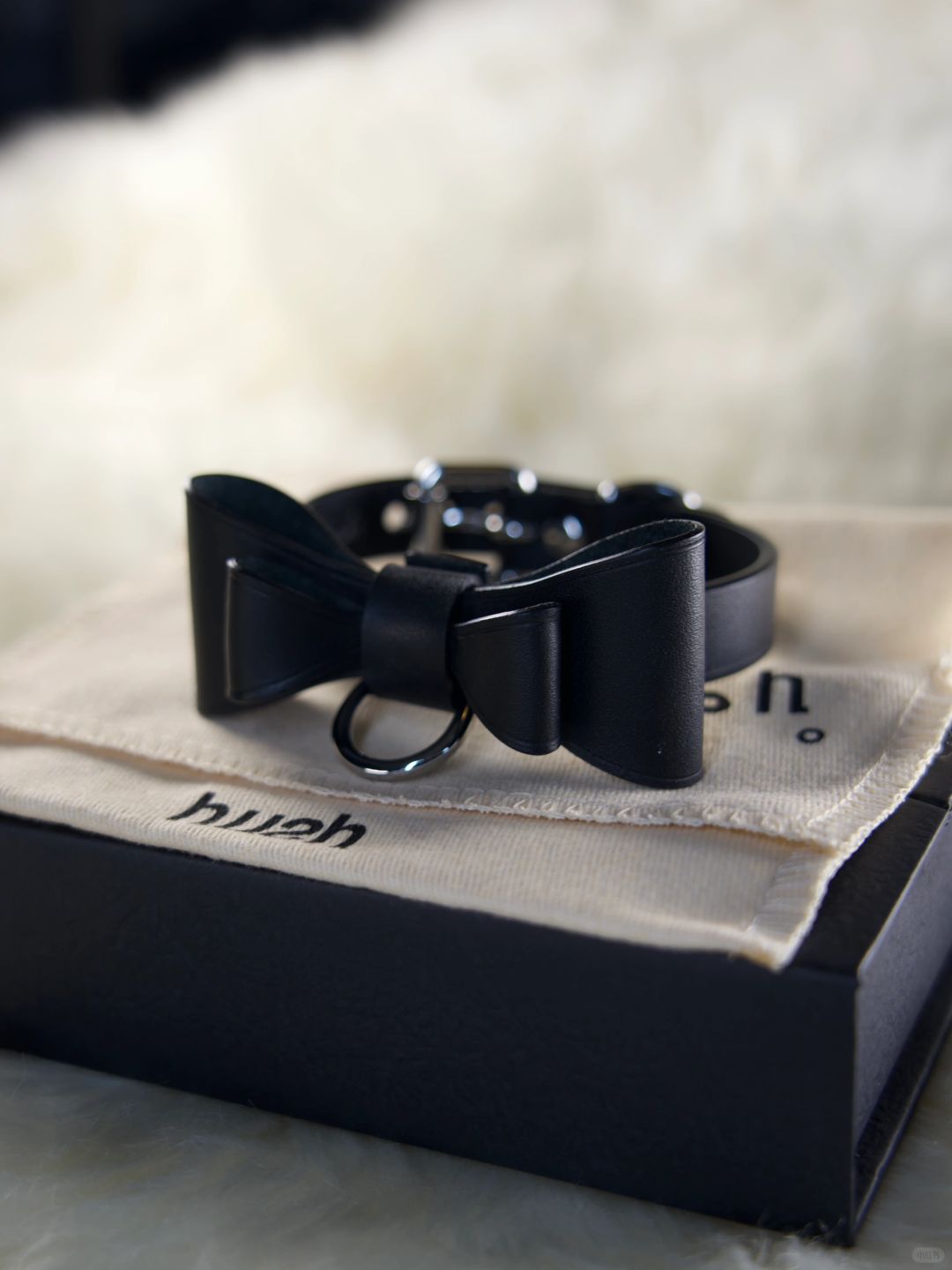 HushCrafts black leather collar with an elegant bow and O-ring design. A stylish and versatile accessory, perfect for adding a bold statement to your look.