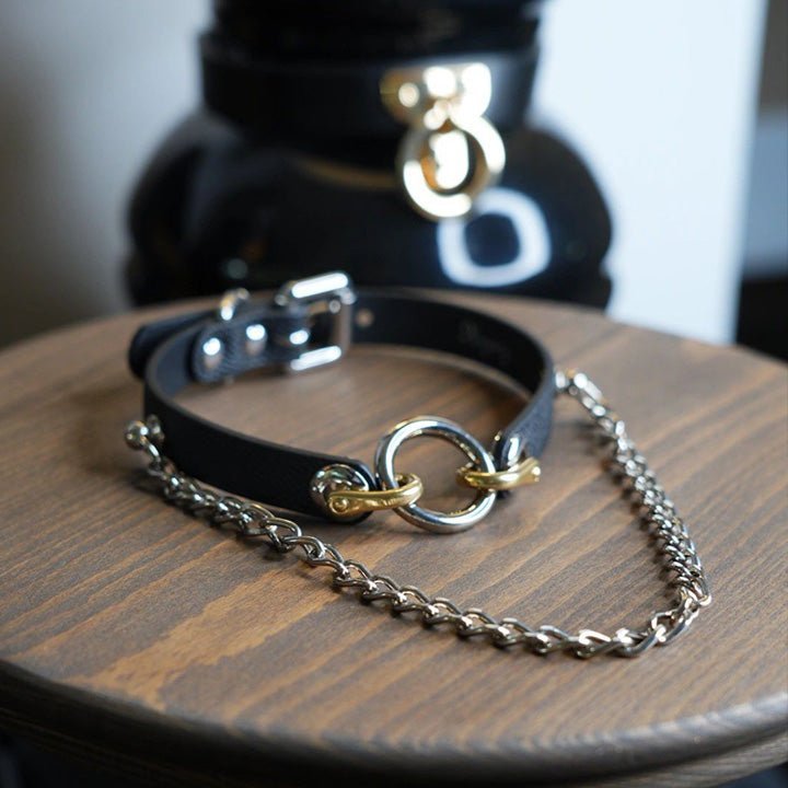 HushCrafts leather collar with an O-ring necklace, featuring a small chain leash for women, blending elegant design with a bold BDSM aesthetic.