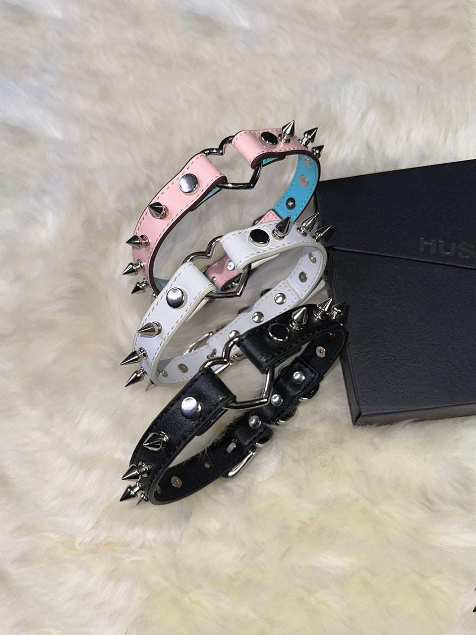 HushCrafts spiked leather collars in black, white, and pink. Bold and stylish design with metal spikes for an edgy look.